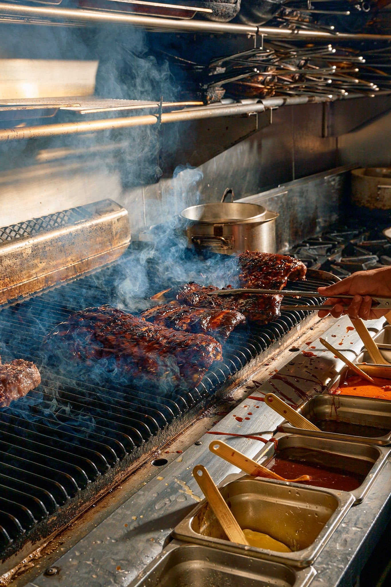 Ribs cooking over the grill during a Times Casey kitchen shoot